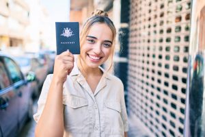 young-beautiful-blonde-caucasian-woman-smiling-happy-outdoors-sunny-day-showing-australia-passport-