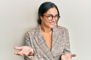 young-brunette-woman-wearing-business-jacket-glasses-smiling-cheerful-open-arms-as-friendly-welcome-positive-confident